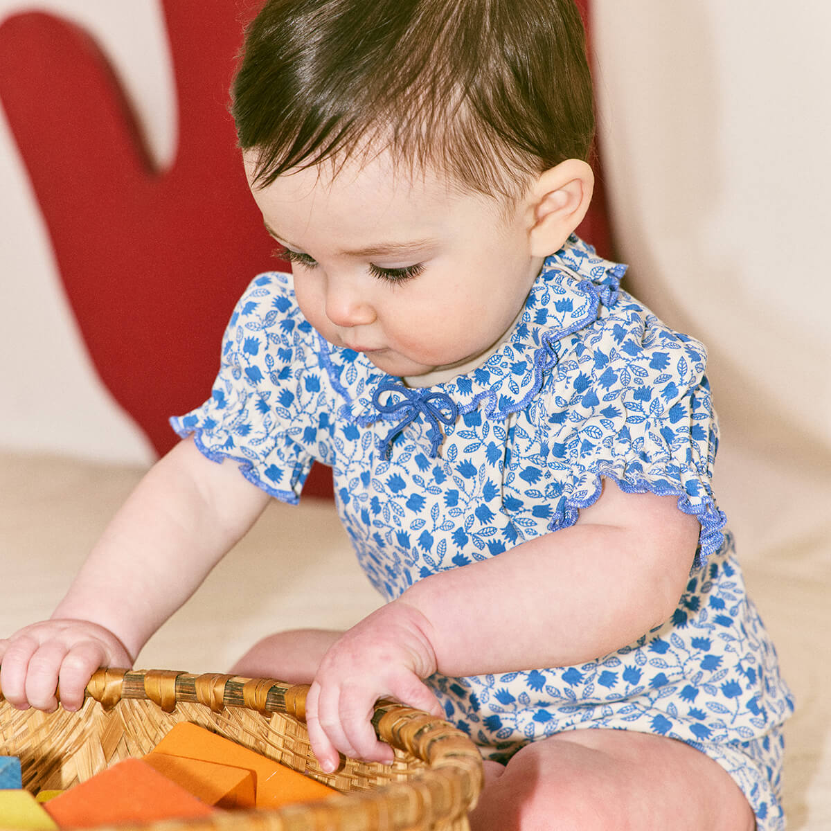 Baby Patricia Onesie in Blue Ribbon Lisse Fields by Misha & Puff